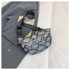 Detail view of a trendy snakeskin pattern crossbody dumpling bag with black adjustable strap.