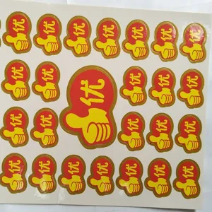 Close-up detail of red adhesive reward stickers featuring thumbs up icons and excellent text.