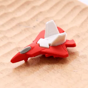 Detail view of creative fighter jet shaped rubber eraser, red and white cartoon gift.