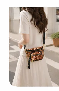 Women's stylish leopard print chest bag detail, featuring multi-pocket design and wide strap.
