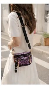 Fashionable purple leopard print waist bag with multi-zipper pockets and wide strap.