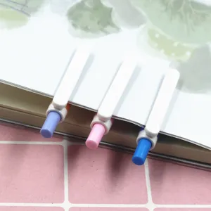 Close-up detail of cute automatic mechanical pencils with colorful push buttons clipped on paper.