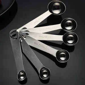 Set de cucharas medidoras de acero inoxidable con grabados de capacidad para cocina y repostería.