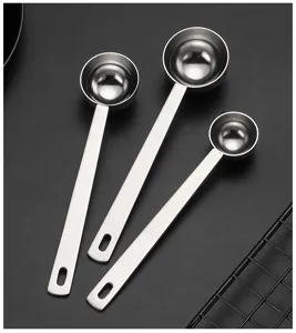 Stainless steel measuring spoon detail view, long handle coffee powder scoop design for kitchen baking.