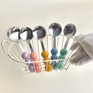 Exquisite detail view of the cute macaron color stainless steel spoon with three colorful beads.