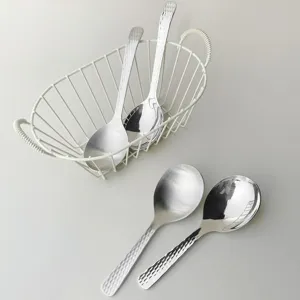 Stainless steel serving spoon set with hammered texture handle for home and hotel dining use.