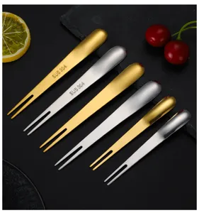 Ensemble de fourchettes à fruits en acier inoxydable, or et argent, détails élégants.