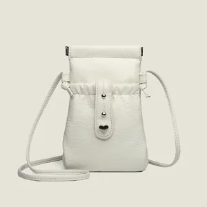 White PU leather crossbody phone bag with drawstring and heart charm for women daily use.