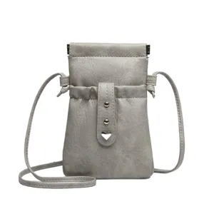 Grey PU leather mini crossbody phone bag with drawstring and cute metal heart buckle detail.