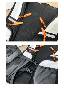 Detail view of lightweight running hydration vest with mesh fabric and orange zipper pulls.