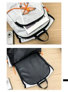 Lightweight outdoor sports backpack in white and black with orange bungee cord for hiking.