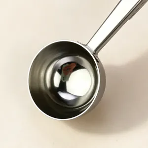 Stainless steel measuring spoon close-up detail showcasing smooth interior bowl and handle.