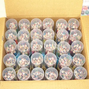Detailed view of bulk colored pencils in clear plastic buckets inside a cardboard box packaging.