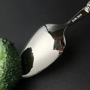 Stainless steel spoon detail view, premium 304 material, polished finish cutlery close up.