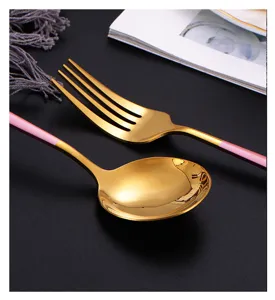 Gros plan détaillé de la fourchette et de la cuillère de style portugais à manche plat rose.