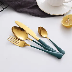 Detail view of the elegant green and gold stainless steel cutlery set with utensils.