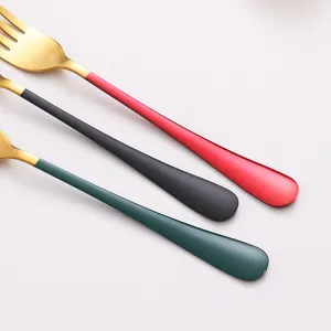 Stainless steel western dining fork close-up, golden fork head with colorful handle detail.