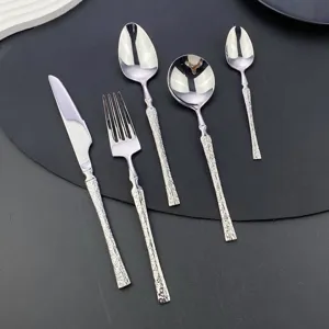 304 stainless steel flatware set with textured handle, dinner knife, fork and spoon detail.