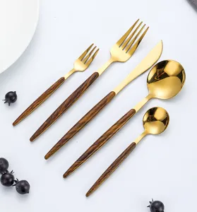Details of gold stainless steel cutlery set with wood grain handle, western table spoon fork.