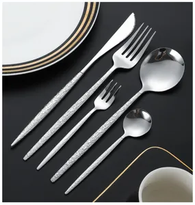 Stainless steel cutlery detail view featuring textured handles, elegant tableware set.