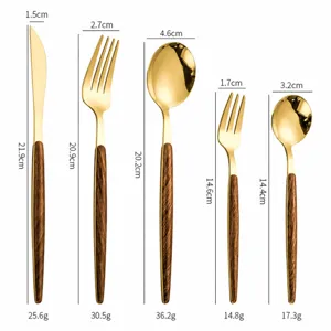 Gold stainless steel cutlery set with faux wood handles, including knife, fork and spoon.