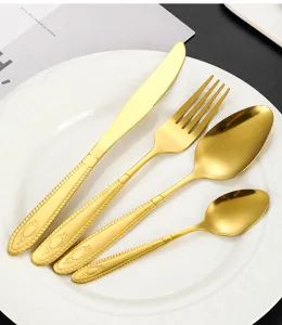 Detailed view of luxury gold stainless steel flatware set featuring elegant embossed handles.