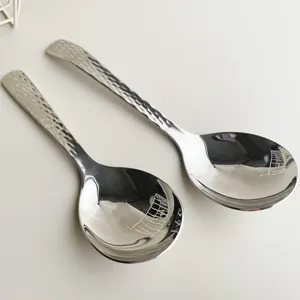 Stainless steel serving spoon with hammered handle design, perfect for home and hotel use.