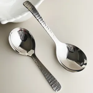 Stainless steel serving spoon with hammered handle design, perfect for home hotel dining table.