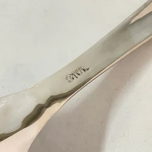 Primo piano dettagliato di un manico di cucchiaio in acciaio inossidabile 316L di qualità.