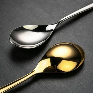 Stainless steel spoon detail shot showcasing polished silver and gold flatware finish.