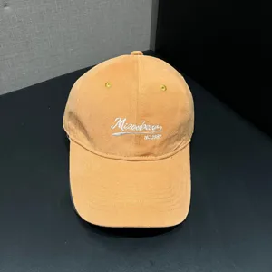 Detailed close-up shot of the front embroidery logo on the casual apricot baseball cap.