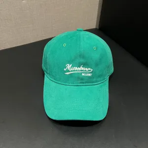 Green unstructured baseball cap with stylish front embroidery, casual unisex design for daily wear.