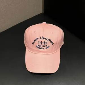 Pink cotton baseball cap with stylish front embroidery, soft top casual hat for daily wear.