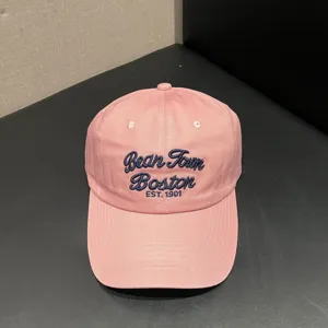 Classic pink vintage soft top baseball cap featuring blue embroidered lettering detail.