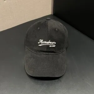 Detail view of the classic black cotton letter embroidered baseball cap, soft top.