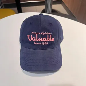 Navy blue embroidered baseball cap with pink text, stylish casual headwear for daily wear.