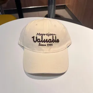 Beige baseball cap featuring front embroidered lettering and casual soft-top design detail.