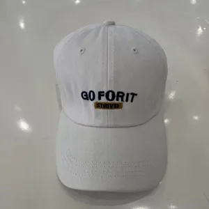 Detailed shot of white baseball cap featuring front embroidery text GO FOR IT and STRIVE!