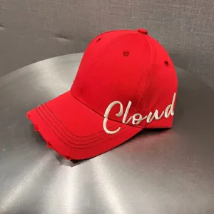 Red baseball cap with white embroidered Cloud letters, distressed brim, casual streetwear hat.