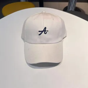 White streetwear baseball cap with blue 3D embroidered letter A for men and women daily wear.