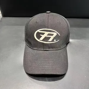 Classic black washed cotton baseball cap with stylized front embroidery, casual streetwear style.