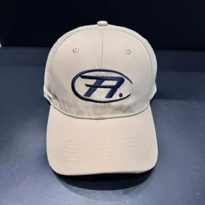 Vintage washed cotton baseball cap with embroidered letter logo, curved brim detail.