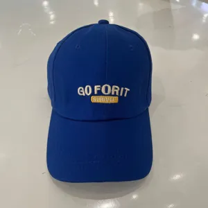 Blue cotton baseball cap featuring stylish white and yellow embroidered front lettering.