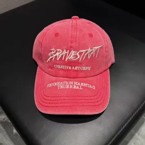 Detail view of pink washed cotton baseball cap featuring stylish front embroidery text.