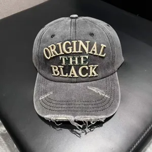 Vintage washed denim baseball cap with distressed brim and bold front embroidery letters.