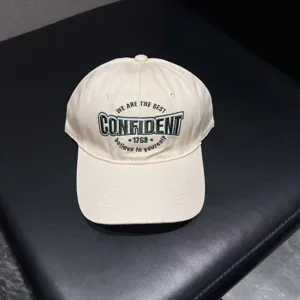 Classic beige embroidered baseball cap for women and men, stylish curved brim streetwear hat.