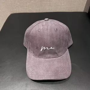 Detailed close-up view of the washed cotton baseball cap with embroidered me detail.