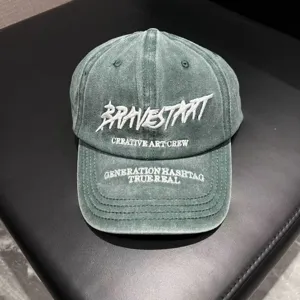 Washed green cotton baseball cap with stylish white embroidery letters, vintage street style.