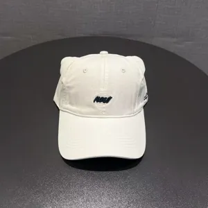 Close-up detail of the white baseball cap featuring cute cat ears and front embroidery.