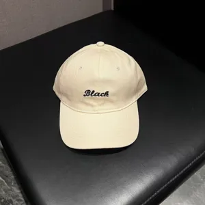 Beige baseball cap for women and men, featuring stylish black embroidery letter design for casual wear.